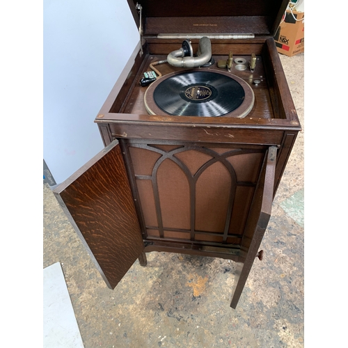 301 - His Masters Voice gramophone in oak case with cartridge and handle