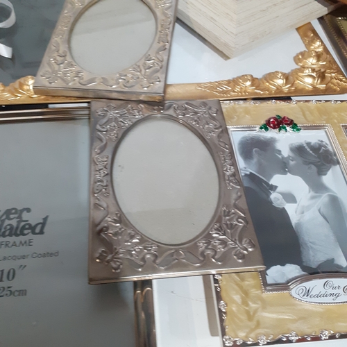 18A - Large quantity of smaller size picture frames. Various designs, including silver plate, wood and bra... 