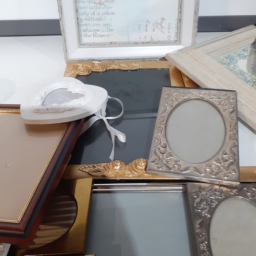 18A - Large quantity of smaller size picture frames. Various designs, including silver plate, wood and bra... 