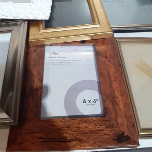 18A - Large quantity of smaller size picture frames. Various designs, including silver plate, wood and bra... 