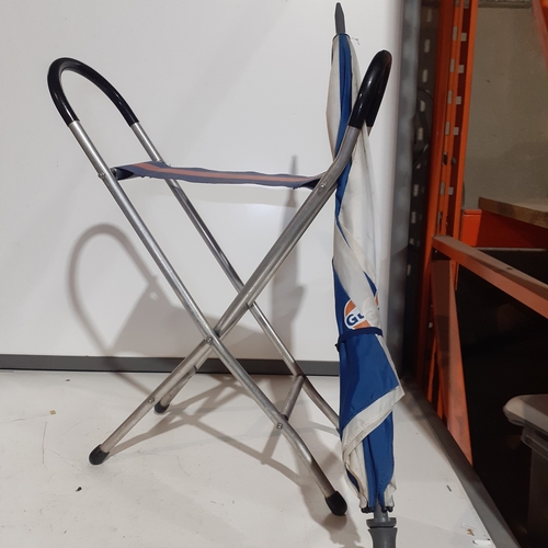 10 - Aluminum framed fishing seat and Gulf umbrella. Seat marked Mercedes Benz and both good condition bu... 