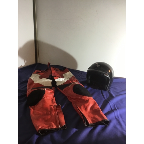 481 - A pair of red leather motorcycle trousers and open faced black Frank Thomas helmet