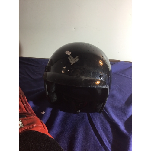 481 - A pair of red leather motorcycle trousers and open faced black Frank Thomas helmet