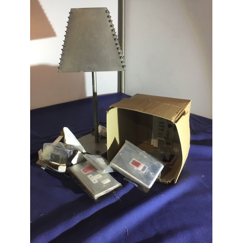 486 - Quantity of stainless light switches, and metal table lamp with metal shade