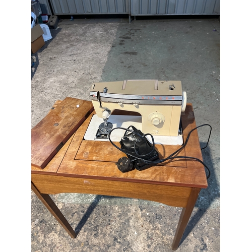 864 - Singer sewing machine with wooden table