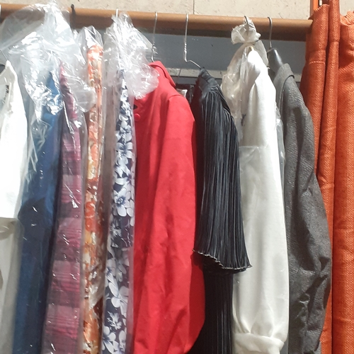 138A - Large rail full of ladies clothing, evening wear, suits, dresses and more. Good,  clean condition