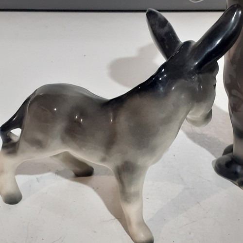 23 - 2 x cute porcelain donkeys. Lovely features with no damage. Large one approx 10 inches