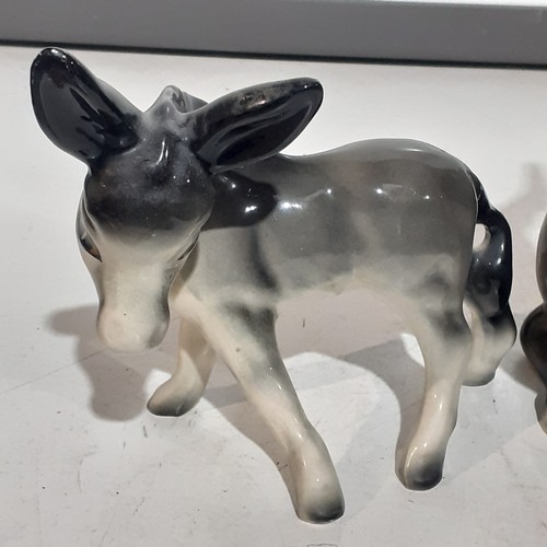 23 - 2 x cute porcelain donkeys. Lovely features with no damage. Large one approx 10 inches