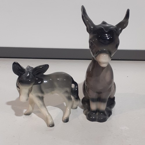 23 - 2 x cute porcelain donkeys. Lovely features with no damage. Large one approx 10 inches