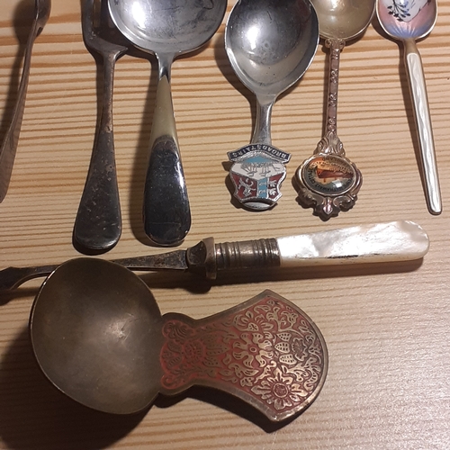 109A - Mixed Cutlery. Includes sugar spoons and sugar tongs, forks with mother of pearl looking handles, br... 