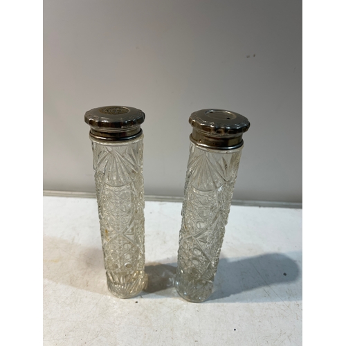 106 - Pair of cut glass hat pin jars with silver metal lids