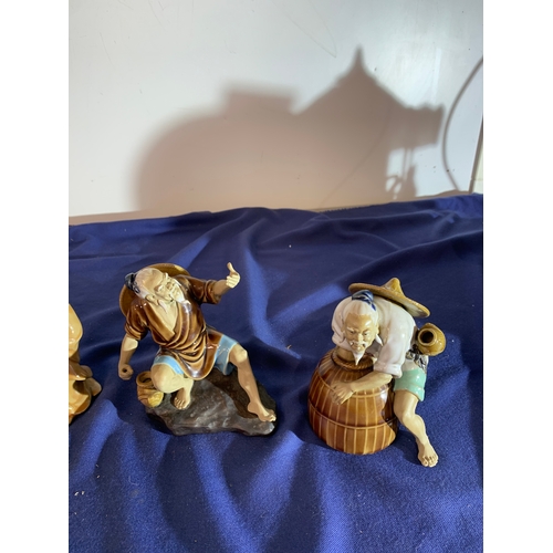 19 - 4 oriental mud men ceramic figures