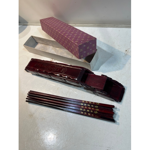 145 - Mahogany case with oriental chopsticks