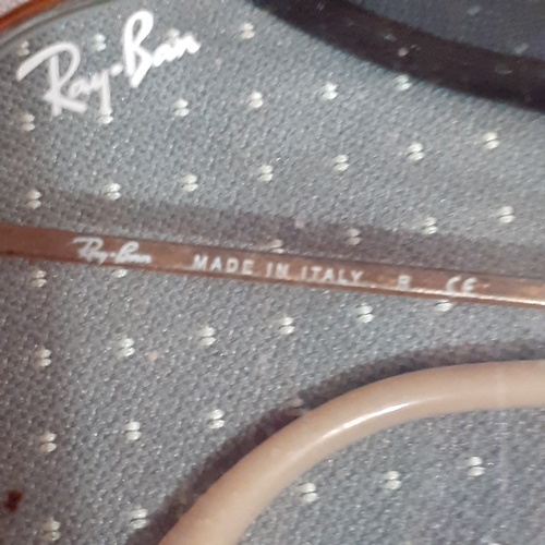 182A - 2 pairs of sunglasses. One genuine Rayban Evolve and O-Luminum Hatchet.