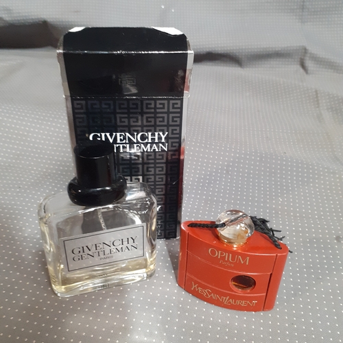 183A - 2 perfume bottles. One full Opium YvesStLaurent and a mostly used Givenchy Gentleman. Both genuine