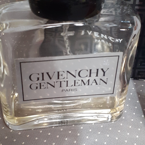 183A - 2 perfume bottles. One full Opium YvesStLaurent and a mostly used Givenchy Gentleman. Both genuine