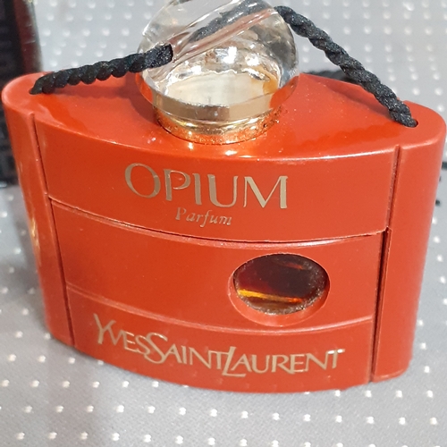 183A - 2 perfume bottles. One full Opium YvesStLaurent and a mostly used Givenchy Gentleman. Both genuine