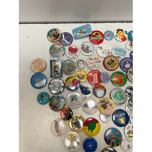 11 - Quantity of collectible pin badges inc ford escort, stamp bug, Jurassic park and more