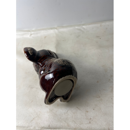 18 - Pair of brown Foster’s pottery ornaments - one being a money box