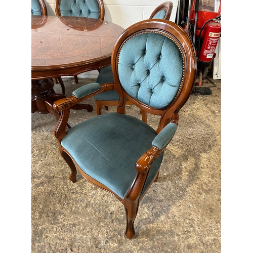 253 - Polished oval dining table with rich wood finish and ornate pedestal base. Paired with six tufted, u... 