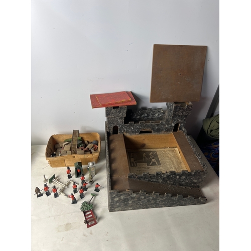 193 - Wooden play castle with quantity of lead Britains soldiers, guard tower and petrol pump