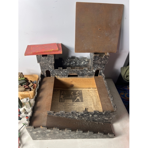 193 - Wooden play castle with quantity of lead Britains soldiers, guard tower and petrol pump