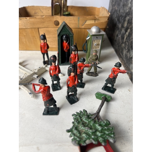 193 - Wooden play castle with quantity of lead Britains soldiers, guard tower and petrol pump