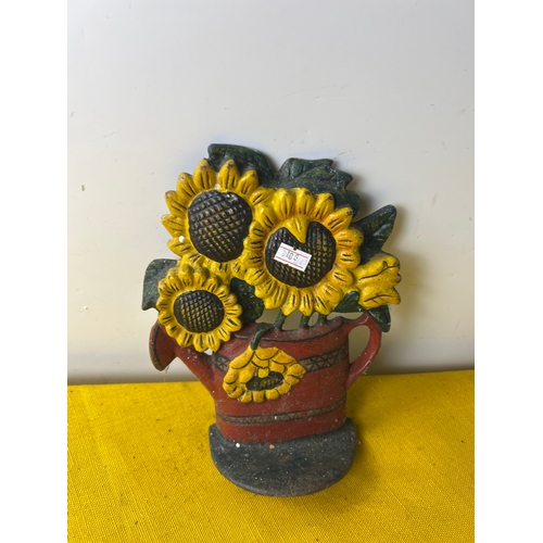 67 - Cast iron door stop of sunflowers in a watering can