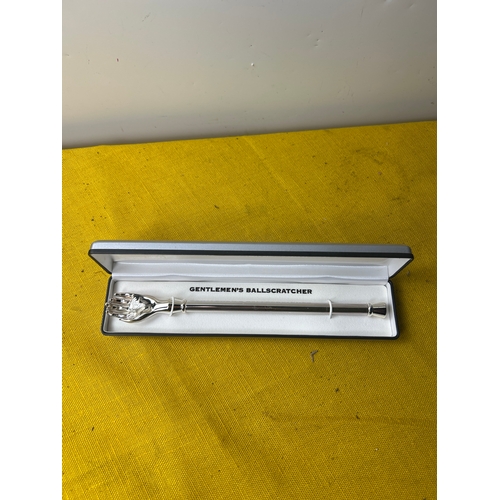70 - Novelty ‘gentleman’s ball scratcher’ in display case