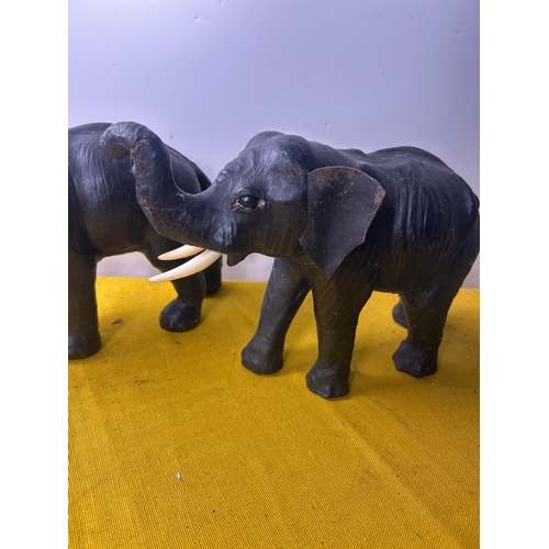 2 - Pair of leather clad decorative elephants with plastic tusks - 35cm long