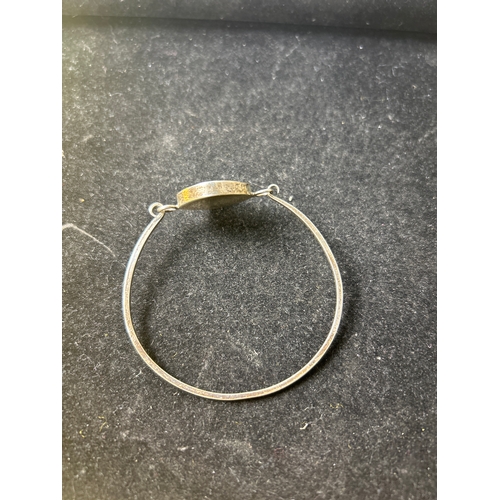 16 - Sterling silver bangle, ring (size O) and earrings with decorative purple & clear central stone set ... 