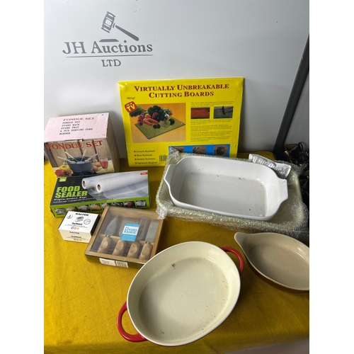 56 - Kitchen lot to inc mainly unused roasting dishes, cheese knives, fondue pot and more