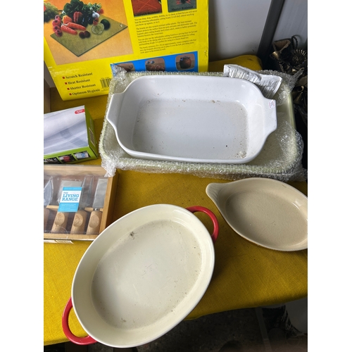 56 - Kitchen lot to inc mainly unused roasting dishes, cheese knives, fondue pot and more