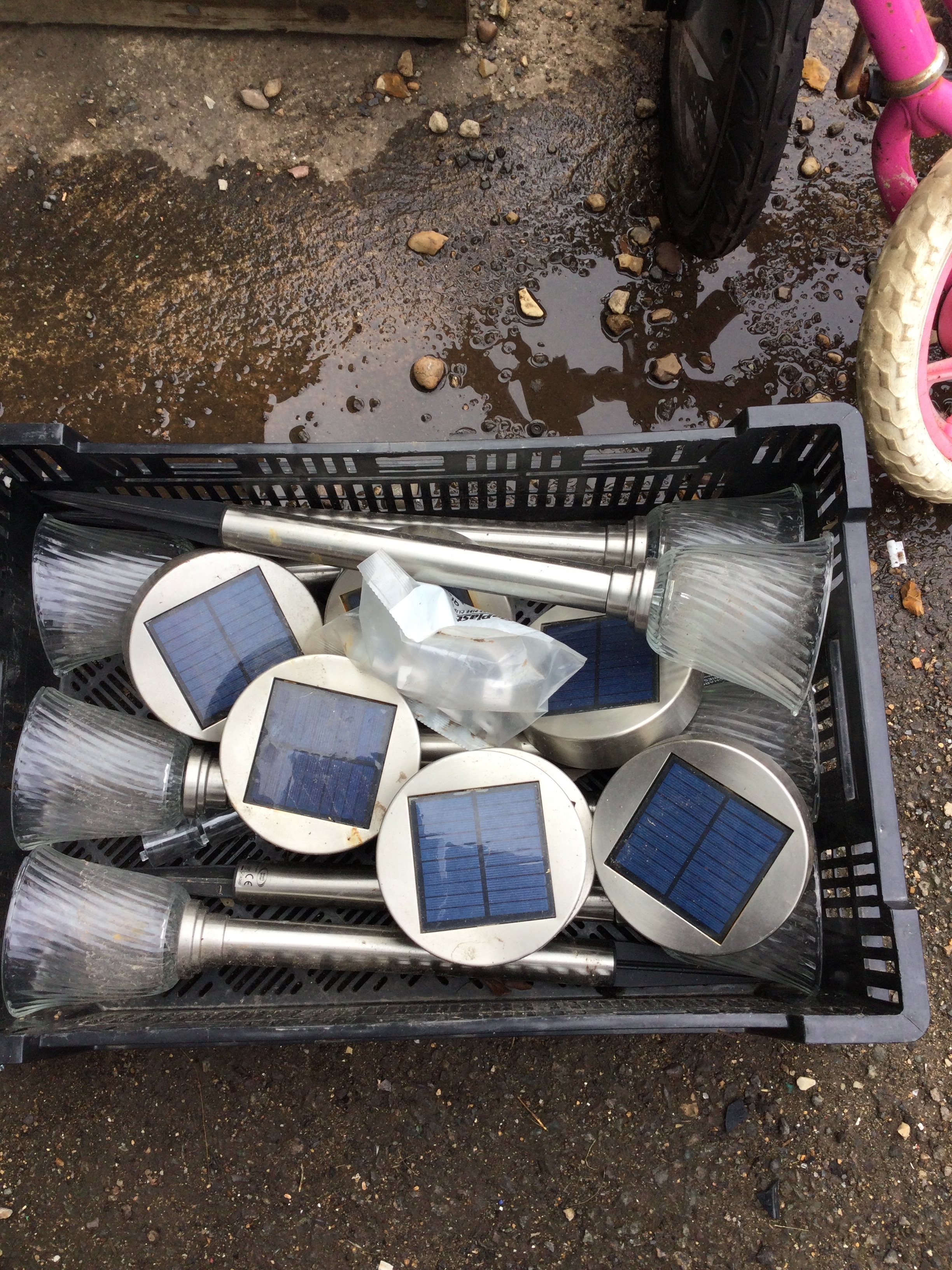 Crate containing glass and metal solar lights
