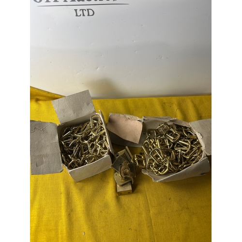 2x boxes full of small brass buckles