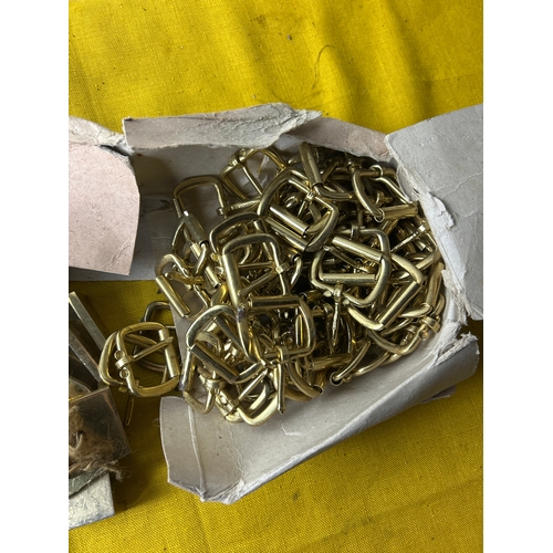 2x boxes full of small brass buckles
