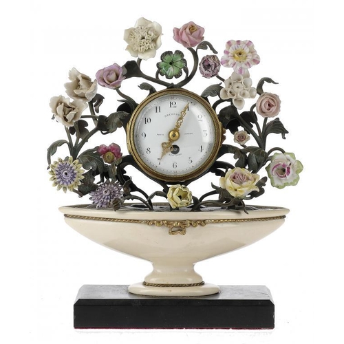 1264 - A FRENCH GILTMETAL AND PORCELAIN CLOCK, EARLY 20TH C  the drum cased timepiece with enamel dial  set... 