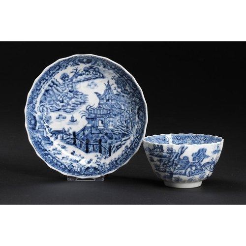 60 - A CAUGHLEY BLUE AND WHITE SHANKED TEA BOWL AND SAUCER, C1790 printed with the Striped Temple pattern... 