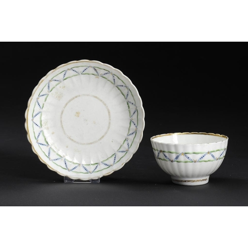 66 - A CAUGHLEY POLYCHROME FLUTED TEA BOWL AND SAUCER, C1792-95 with the green Zig-Zags pattern, saucer 1... 