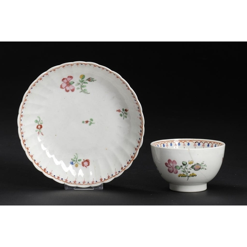 67 - A CAUGHLEY POLYCHROME TEA BOWL AND MATCHING FLUTED SAUCER, C1792-95  in the Pink Gillyflowers patter... 