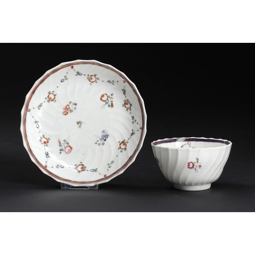 71 - A CAUGHLEY POLYCHROME SHANKED TEA BOWL AND SAUCER, C1792-95  enamelled with the Rose Swags pattern, ... 