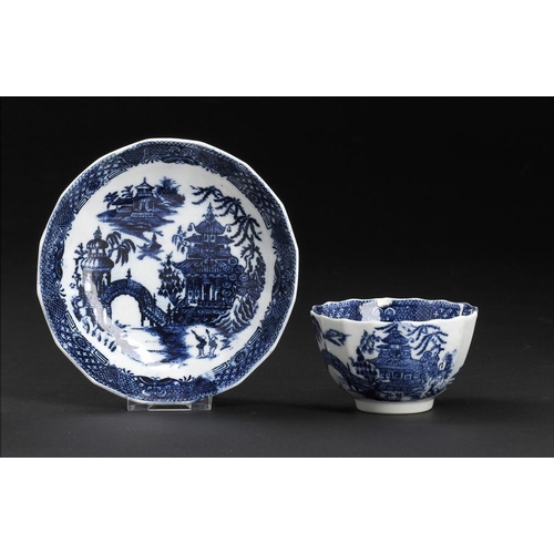 94 - A CALCUT BLUE AND WHITE FLUTED TEA BOWL AND SAUCER, C1794-96  printed with the Round Arched Bridge p... 