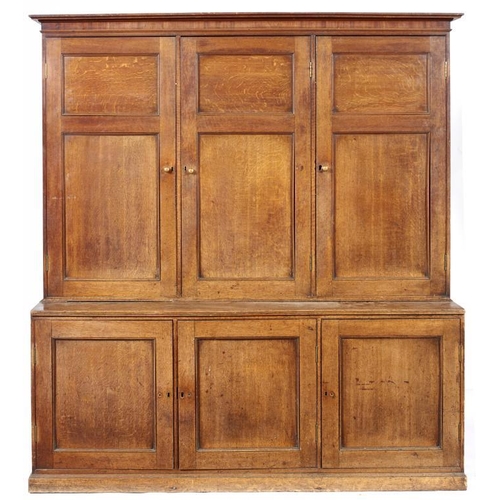 1016 - A GEORGE III OAK HOUSEKEEPER'S CUPBOARD, EARLY 19TH C   the upper part fitted with shelves enclosed ... 