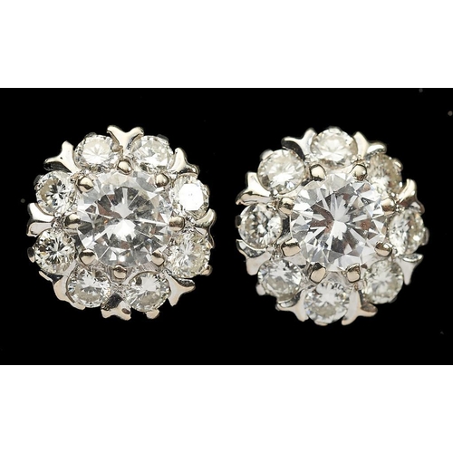 107A - A PAIR OF DIAMOND CLUSTER EARRINGS with central round cut diamond surrounded by eight smaller diamon... 