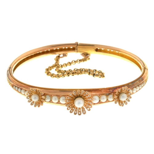 77 - A CULTURED PEARL AND DIAMOND BANGLE with old cut diamonds, guilloche set in gold, 65mm, unmarked, 20... 