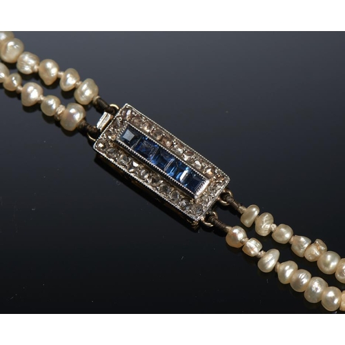 88 - A NATURAL PEARL NECKLACE WITH SAPPHIRE AND DIAMOND CLASP baroque pearls of approx 2mm each, 38cm, 10... 