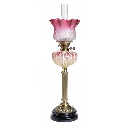 913 - A VICTORIAN BRASS OIL LAMP, C1900  with semi opalescent shaded  cranberry   glass fount and a contem... 