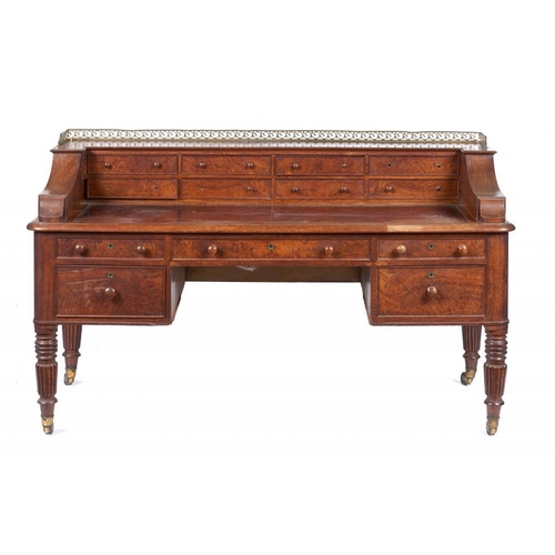 940 - A WILLIAM IV POLLARD OAK DESK, C1830 the leather inlet top with brass gallery to the superstructure,... 