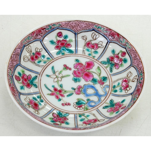 194 - A CHINESE FAMILLE ROSE 'RUBY BACK' SAUCER, PAINTED IN THE CENTRE WITH FLOWERS GROWING FROM A BLUE HO... 