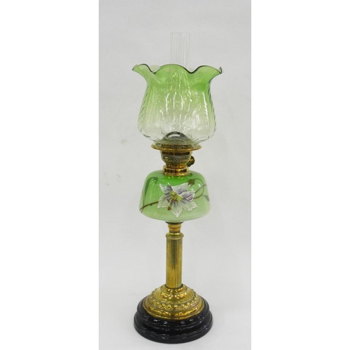 313 - A VICTORIAN BRASS REEDED COLUMNAR OIL LAMP, THE SHADED GREEN GLASS FOUNT ENAMELLED WITH A LILY, BRAS... 